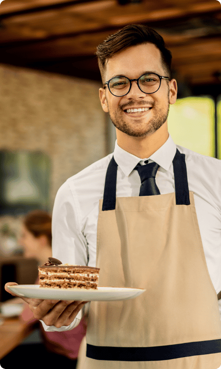 Smiling restaurant professional holding a tray
